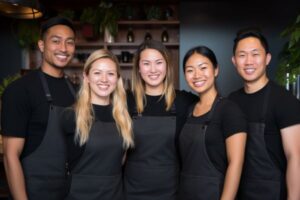 A Group of People Wearing Black Aprons